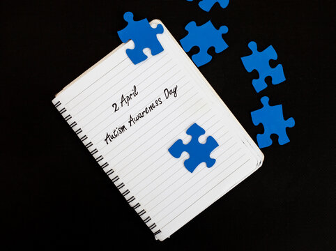 2April Autism Awareness Day written on notebook