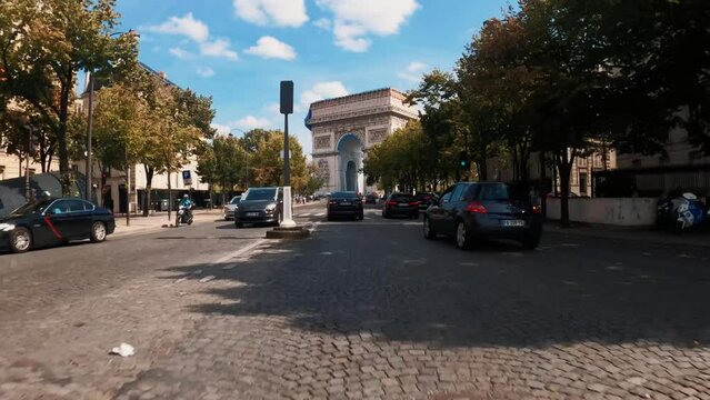 POV car driving Arc de Triomphe Paris Champs Elysees sunny avenue
