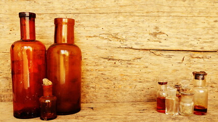 Antique Medicine Bottles, Victorian Era, on a original 1800s wooden background with space for your text or design - 491685725