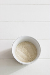 Dip dressing greek yogurt tahini overhead wooden table vertical
