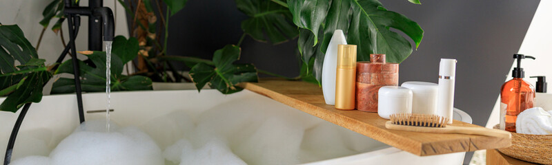 Wooden shelf for beauty and body care products on wooden shelf over modern white bubble filled...