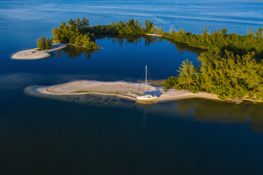 Aerial view of a sailboat docked along the shoreline at Indian River, Sebastian Oaks, Florida, United States.