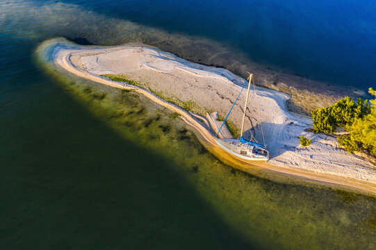 Aerial view of a sailboat docked along the shoreline at Indian River, Sebastian Oaks, Florida, United States.