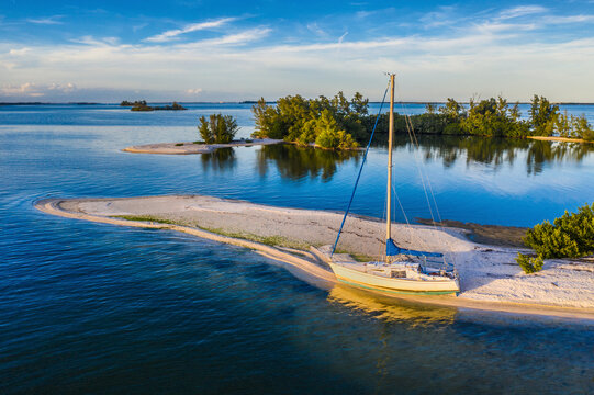 Aerial view of a sailboat docked along the shoreline at Indian River, Sebastian Oaks, Florida, United States.