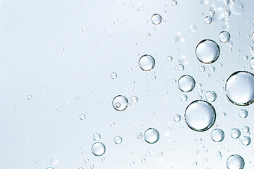 champagne bubbles or cosmetic liquid water bubbles floats drops surface over a blurred background