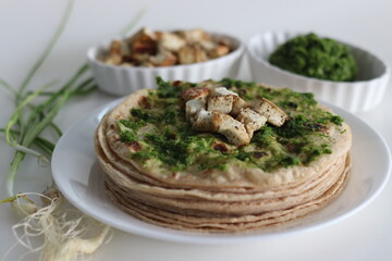 Indian flat bread smeared with green garlic condiment and served with sauteed cottage cheese