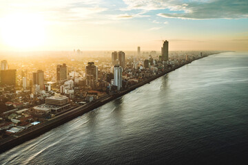 Aerial view of sunrise over Colombo city metropolis standing near Indian ocean in Sri Lanka.