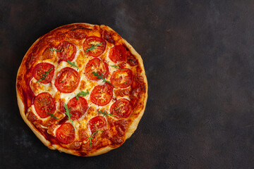 Pizza on a dark background, copy space