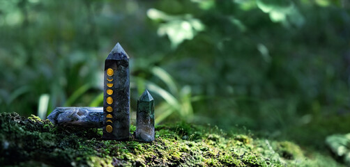 Crystals with moon phases image on moss in mysterious forest, natural green background. quartz mineral for healing magic Crystal Ritual, Witchcraft, spiritual esoteric practice - obrazy, fototapety, plakaty