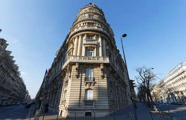 The facade of traditional French house with typical balconies and windows. Paris.