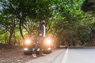 Man at car near road