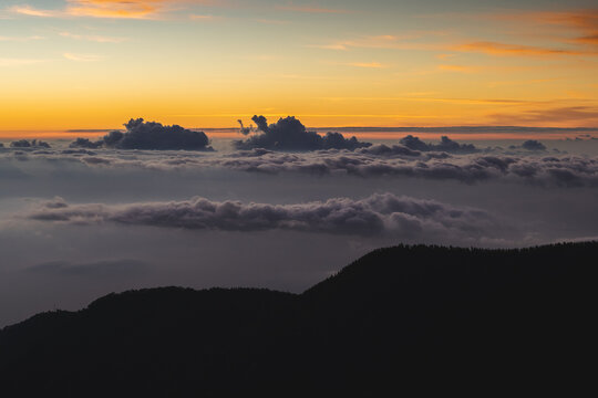 Mountains near clouds at sunset time