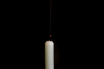 candle. extinguished candle on a black background