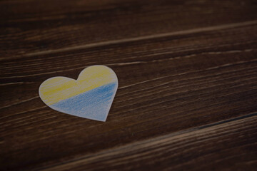 Heart pattern, yellow-blue flag of Ukraine. revention of hostilities in Ukraine. Peace concept. No war, stop war, russian aggression. Top view