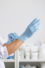 Hands in blue gloves