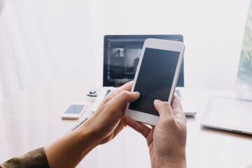 Business partnership coworkers using a tablet to chart company financial statements report and profits work progress and planning in office room.