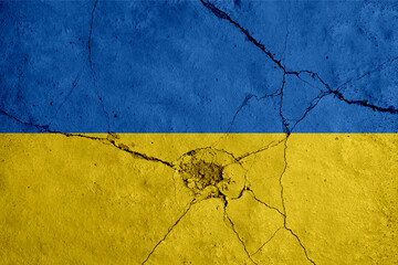 Ukraine painted flag on a wall with a crack. War, conflict between Ukraine and Russia