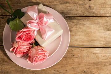 Fototapeta na wymiar Romantic dinner table on rustic background. Love cutlery for Valentine's or Mother's day, Wedding