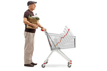 Full length profile shot of a senior with a paper bag and a shopping cart with a bar chart diagram