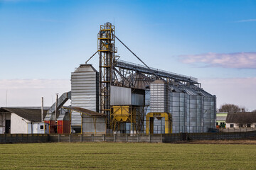 Obraz premium agro silos granary elevator. Silos on agro-processing manufacturing plant for processing drying cleaning and storage of agricultural products, flour, cereals and grain.