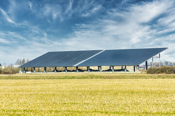 A huge solar plant in front of  a rural landscape