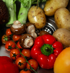 Freshly washed organic homegrown vegetables on the sink. Concept: hygiene, healthy food, vegan, vegetarian lifestyle.