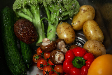 Freshly washed organic homegrown vegetables on the sink. Concept: hygiene, healthy food, vegan, vegetarian lifestyle.
