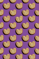 pattern of palmier cookies on purple background