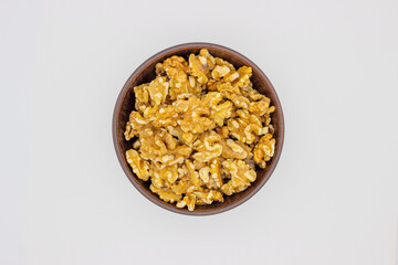 Peeled walnuts in brown plate