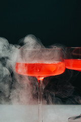 glass of red cocktail with smoke