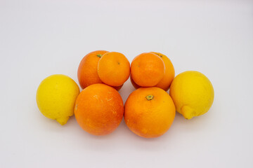 Few oranges, tangerines and lemons on white background.