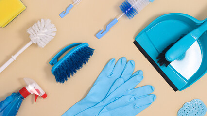Cleaning tools pattern on pastel beige and blue background. Flat lay minimal composition of supplis for house works