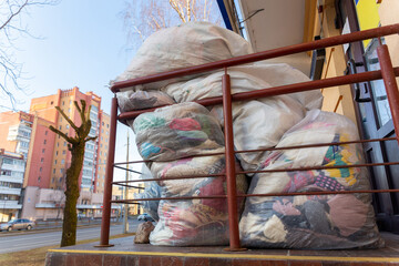 Used clothes and shoes in plastic bags.