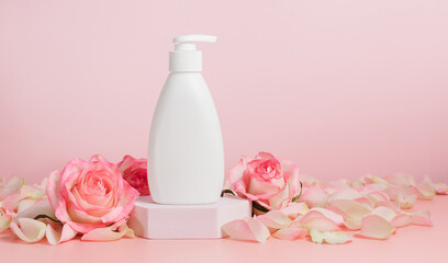 Obraz na płótnie Canvas Mockup cosmetic liquid soap dispenser or body lotion bottle with pink rose, banner size, copy space, natural cosmetic