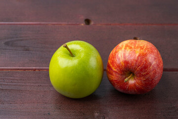 Close up view of green and red apples isolated on wooden background. Healthy food concept.	