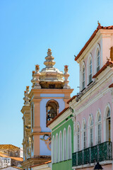 Colorful houses facades with balcony and historic church towers in the famous Pelourinho neighborhood in Salvador, Bahia