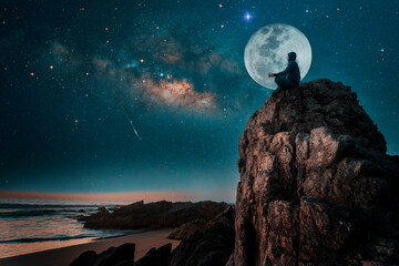 person silhouette sitting on the top of the mountain meditating or contemplating the starry night with Milky Way and Moon background. - Powered by Adobe