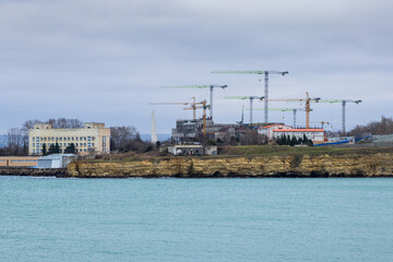 Construction on the sea coast. Lots of construction cranes. Improvement and development in the Crimea. City of Sevastopol.