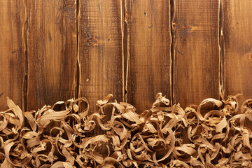 Wood shavings on table background. Wooden shaving at old plank board