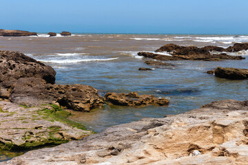 Fototapeta na wymiar Volcanic coast of the Atlantic ocean in the Essaouira on a sunny summer day. Morocco.