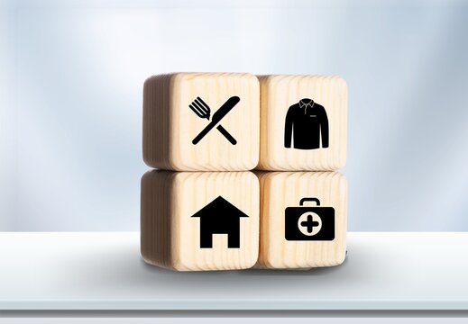 The investor's concept, wooden cube with concept work from home, Planning to buy property concept ,food Clothing, housing, medicine, four basic human needs concept.