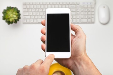 A person plays on Phone. Hold smartphone with a blank screen
