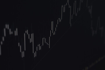 Real-time display of financial market data. Market price changes, stock and currency market fluctuations, investment chart on a black background. Soft focus