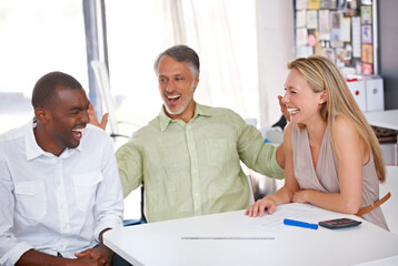 Fototapeta premium Working together on a great design. Three designers having a meeting.