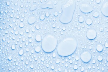 Cosmetic moisturizing liquid drops on blue pastel background. Toner or lotion. Hyaluronic serum