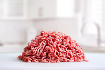 Ground beef heap, minced meat at kitchen table.