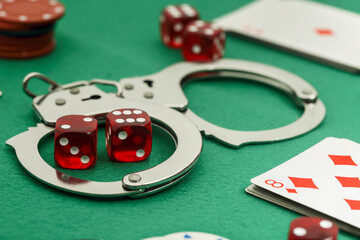 handcuffs on casino table, addiction to gambling concept