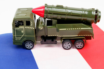 Obraz premium There is a missile system on the flag of France. Symbols of defense and military conflicts.