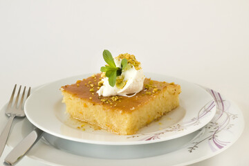 Traditional Turkish Pastry Dessert served with cream,sliced in one portion.Conceptual image