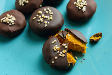 homemade candies in a cut with a pumpkin and orange  in a blue plate
